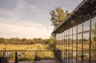 Un conférencier s'adresse à un public assis dans une salle avec un écran de projection et des murs en briques.