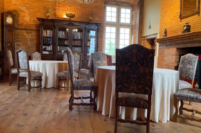 Un conférencier s'adresse à un public assis dans une salle avec un écran de projection et des murs en briques.