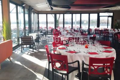 Chambre en bois avec un lit double, une fenêtre, un éclairage mural et une porte fermée.