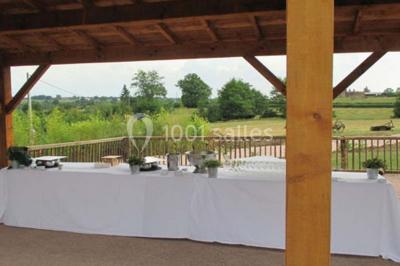 Dortoir sous combles avec murs en pierre, matelas au sol alignés et poutres apparentes.