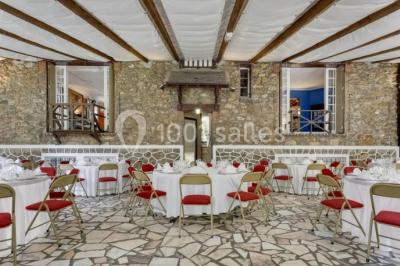 Intérieur élégant avec décorations classiques, horloge, miroir, fleurs et cage décorative dans une lumière tamisée.