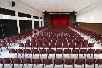 Cuisine professionnelle équipée avec plans de travail en inox, casseroles, assiettes empilées et appareils de cuisson.