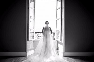 Un grand groupe de personnes en t-shirts verts pose joyeusement devant des véhicules stationnés en extérieur.