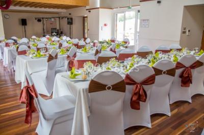 Véranda lumineuse avec murs en briques, grandes baies vitrées noires et vue sur un jardin verdoyant.