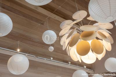 Un couple danse au centre d'une salle éclairée, entouré d'invités assis à des tables.