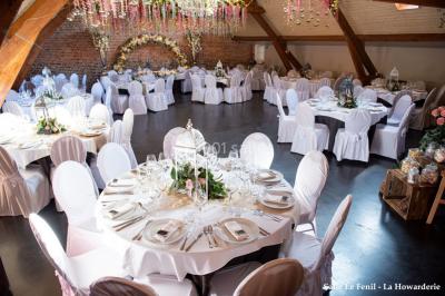Un couple danse au centre d'une salle éclairée, entouré d'invités assis à des tables.
