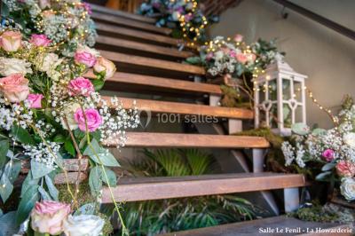 Un couple danse au centre d'une salle éclairée, entouré d'invités assis à des tables.