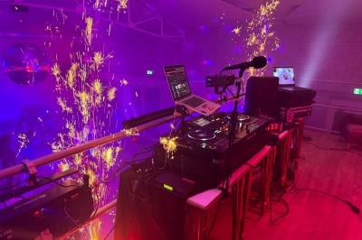 Salle lumineuse avec canapés, tables basses, bar moderne et décoration minimaliste, sous un plafond en verrière.