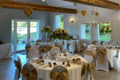 Chambre avec lit double, tête de lit en bois, bureau, chaise, robe blanche sur un mannequin et tableau coloré au mur.