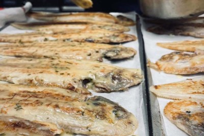 Assiette contenant des feuilles de radicchio garnies de foie gras et de morceaux de pomme disposés en étoile.