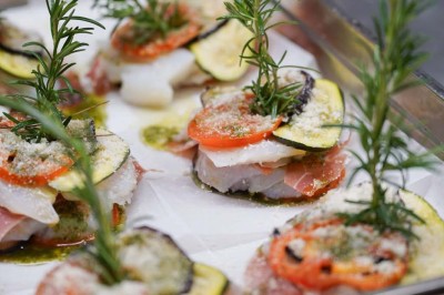 Assiette contenant des feuilles de radicchio garnies de foie gras et de morceaux de pomme disposés en étoile.