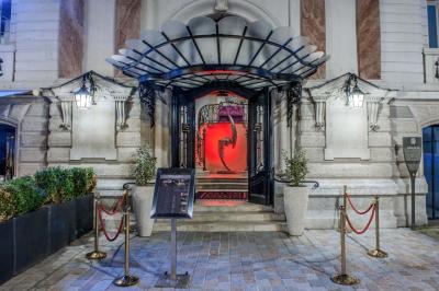Salle avec des fauteuils rayés colorés, murs recouverts de végétation et éclairage tamisé.