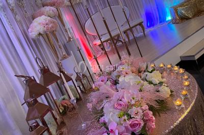 Salle de bain lumineuse avec deux lavabos, miroirs et murs ornés de mosaïques dorées.