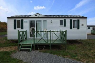 Buffet en bois décoré avec des bocaux de bonbons colorés et une guirlande ’Candy Bar’ dans un cadre rustique.