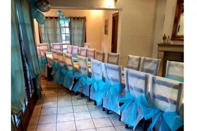 Cuisine rustique avec un bar en bois, éclairage chaleureux, cafetière et ustensiles suspendus au mur.