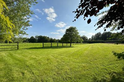 Structure gonflable noire avec cibles circulaires rouges et blanches, installée sur une pelouse en plein air.