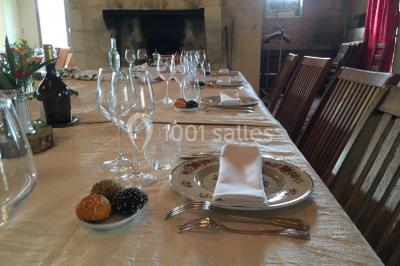 Espace extérieur décoré avec guirlandes lumineuses, fauteuils et tonnelle, au crépuscule dans un jardin.