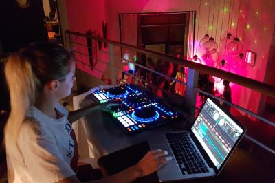 Buffet avec des plats variés, dont des salades, du saumon fumé et des fruits, décoré d'un bouquet de fleurs violettes et…