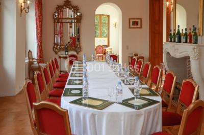 Des bouteilles de vin blanc dans une caisse en bois, avec un bar en bois et des tabourets en arrière-plan.