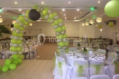 Parking extérieur rempli de voitures, avec un homme debout près d'une Audi noire sous un ciel dégagé.