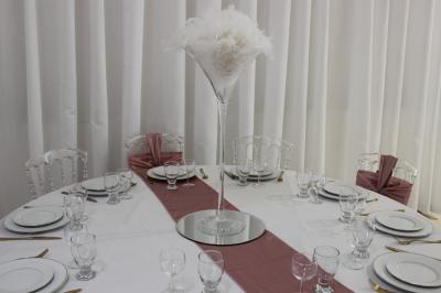 Salle de bain avec lavabo, miroir, urinoir et carrelage blanc et bleu, éclairée par une lumière naturelle.