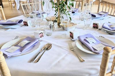 Vue aérienne d'un complexe avec plusieurs bâtiments, un jardin central, un parking et des zones identifiées par des noms.