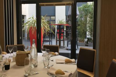 Salle de conférence moderne avec rangées de sièges en bois et éclairage suspendu.