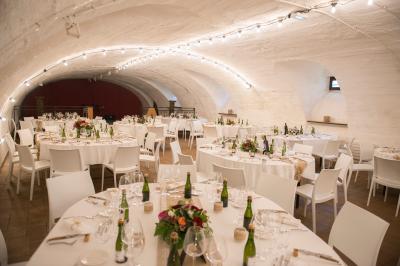 Vue aérienne d'un village avec un étang, des champs, des arbres et des collines à l'horizon.