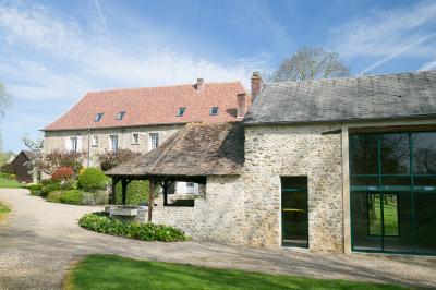 Vue aérienne d'un domaine avec bâtiments, allées, jardins et espaces verts entourés d'arbres.