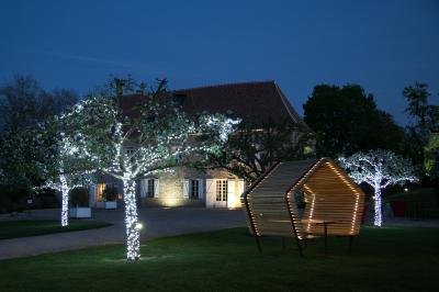 Vue aérienne d'un domaine avec bâtiments, allées, jardins et espaces verts entourés d'arbres.