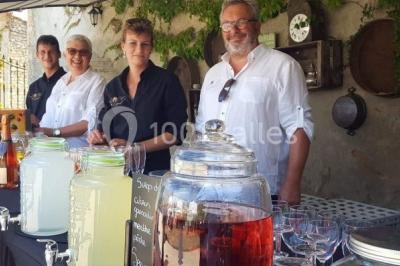Chemin en gravier menant à des chalets en bois entourés de pelouse et d'arbres sous un ciel dégagé.