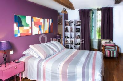 Salle de réception décorée avec des tables dressées, nappes blanches, chaises pliantes et centres de table fleuris.