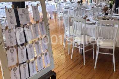 Miniature Location salle Préaux-Bocage (Calvados) - Domaine d'Aslan #6 Paysage rural avec un chemin en gravier, des champs de colza jaunes, des arbres et une terrasse en pierre au premier plan.