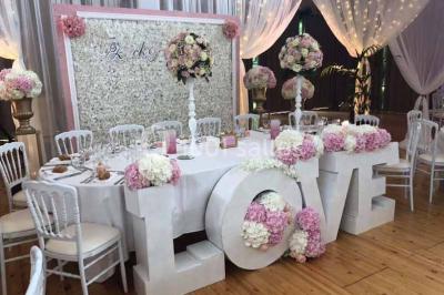 Miniature Location salle Préaux-Bocage (Calvados) - Domaine d'Aslan #16 Paysage rural avec un chemin en gravier, des champs de colza jaunes, des arbres et une terrasse en pierre au premier plan.