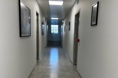 Miniature Location salle Brie-Comte-Robert (Seine-et-Marne) - Event'3 #7 Table en bois rectangulaire entourée de chaises sur une terrasse couverte avec sol en bois et panneaux ajourés.