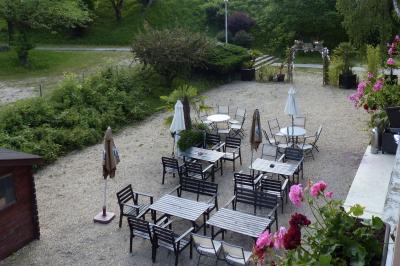Allée avec tapis rouge menant à une arche décorée de fleurs, dans un espace extérieur ensoleillé.