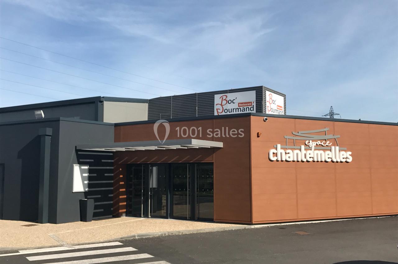 Façade d'un bâtiment commercial moderne avec enseignes ’Chantemelles’ et ’Boc Gourmand’, sous un ciel dégagé.