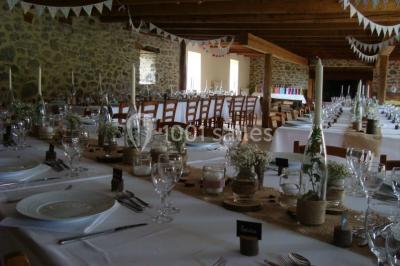 Trois petits chalets colorés en bois, entourés d'arbres et de pelouse, sous un ciel dégagé.
