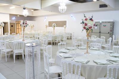 Buffet élégant avec une présentation variée de bouchées salées et sucrées sur des plateaux dorés en salle lumineuse.
