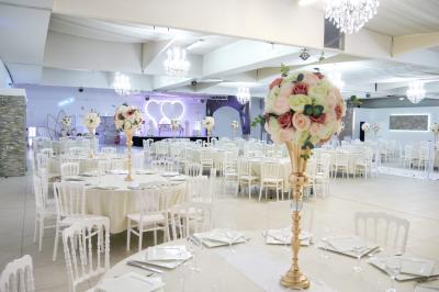 Buffet élégant avec une présentation variée de bouchées salées et sucrées sur des plateaux dorés en salle lumineuse.