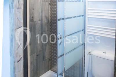 Voiture ancienne blanche décorée de fleurs blanches, stationnée sur un chemin près de vignes et d'un arbre.