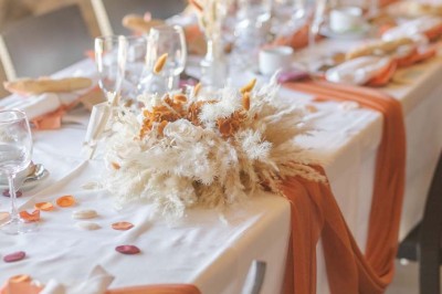 Chambre avec lits superposés en bois, parquet, papier peint floral, accès à une salle de bain et vue sur un jardin.