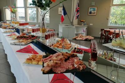 Salle de réception avec une piste de danse, une table dressée à gauche et un équipement de sonorisation au centre.