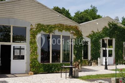Parking extérieur avec plusieurs voitures stationnées, entouré d'arbres et offrant une vue dégagée sur l'horizon.