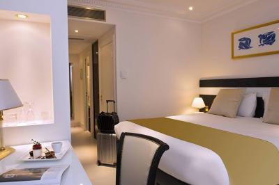 Miniature Location salle Nice (Alpes-Maritimes) - Aston La Scala Nice #23 Tables dressées avec chandelles et fleurs sur une terrasse offrant une vue nocturne sur des bâtiments éclairés.