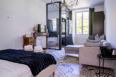 Deux lits simples avec tête de lit noire, coussins jaunes, et tableaux d'animaux anthropomorphes au mur.