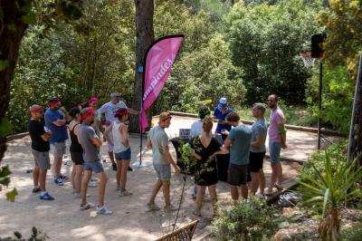 Des personnes allongées sur des transats sous des parasols, profitant du soleil près d'une piscine.