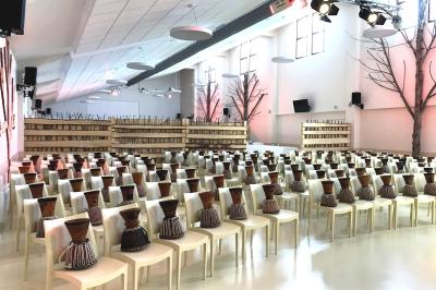 Bassin artificiel entouré de palmiers et de rochers, avec un paysage verdoyant en arrière-plan.