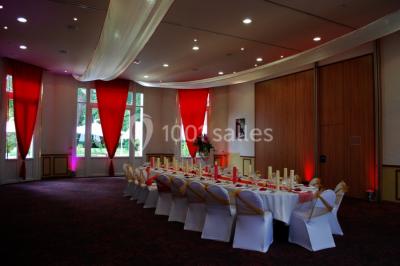 Assiette de noix de Saint-Jacques poêlées, accompagnées de légumes, agrumes et herbes fraîches sur un fond flou.