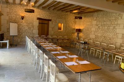 Bouquet de fleurs jaunes et blanches posé sur le capot d'une voiture ancienne noire, sous un ciel bleu.